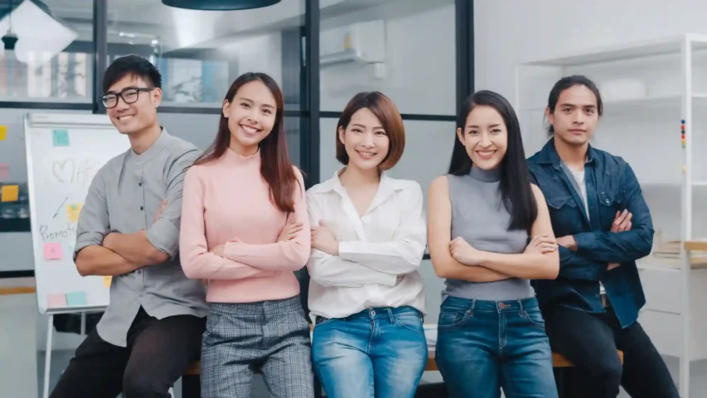 Group of Asia young creative people in smart casual wear smiling