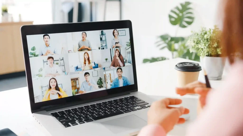 young-asia-businesswoman-using-laptop-talk-colleague-about-plan-video-call-meeting-while-work-from-home-living-room-scaled