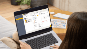 a woman using payroll system on laptop
